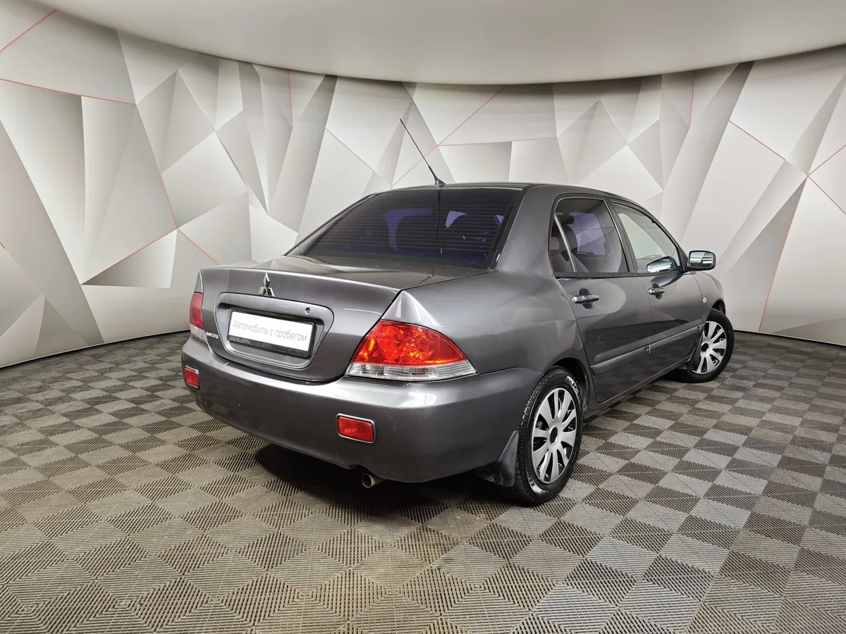 Mitsubishi Lancer 1.6 MT (100 л.с.) Серый в АВИЛОН. Слайд №2