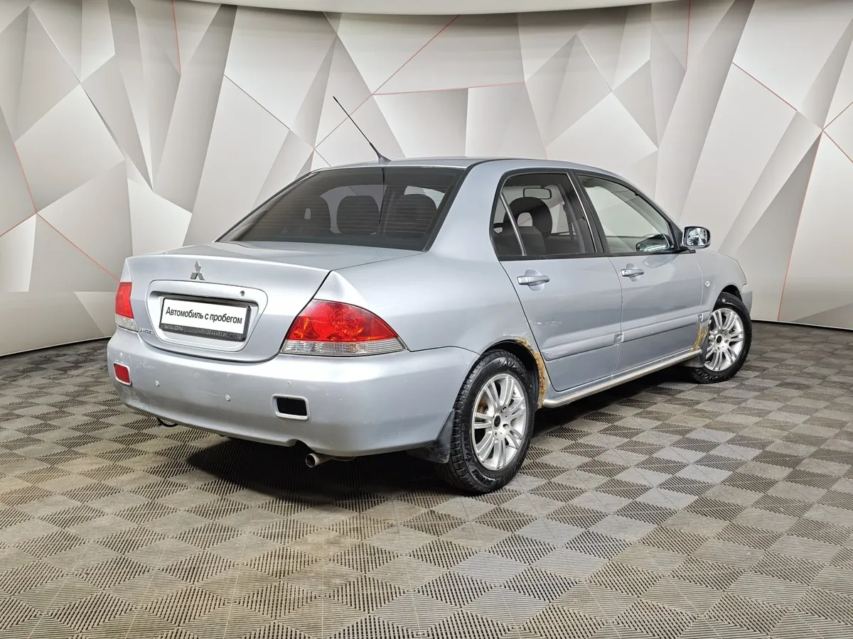 Mitsubishi Lancer 1.6 AT (98 л.с.) Серебристый в АВИЛОН. Слайд №2