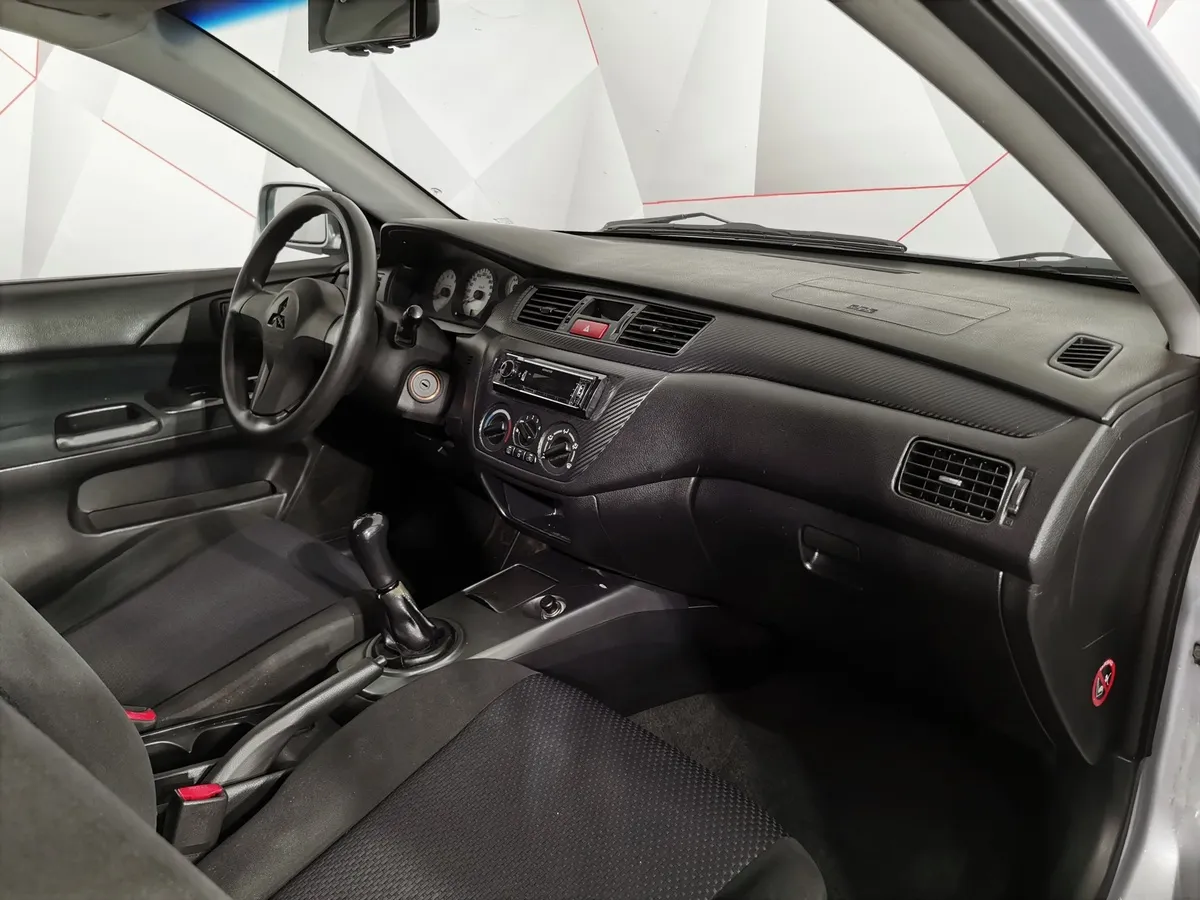 Mitsubishi Lancer 1.6 MT (98 л.с.) Серый в АВИЛОН. Слайд №12