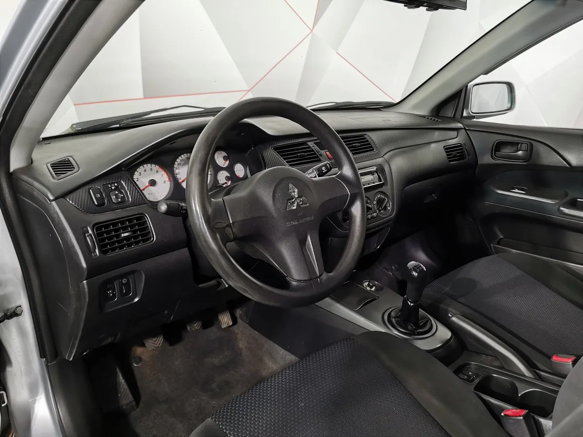 Mitsubishi Lancer 1.6 MT (98 л.с.) Серый в АВИЛОН. Слайд №18