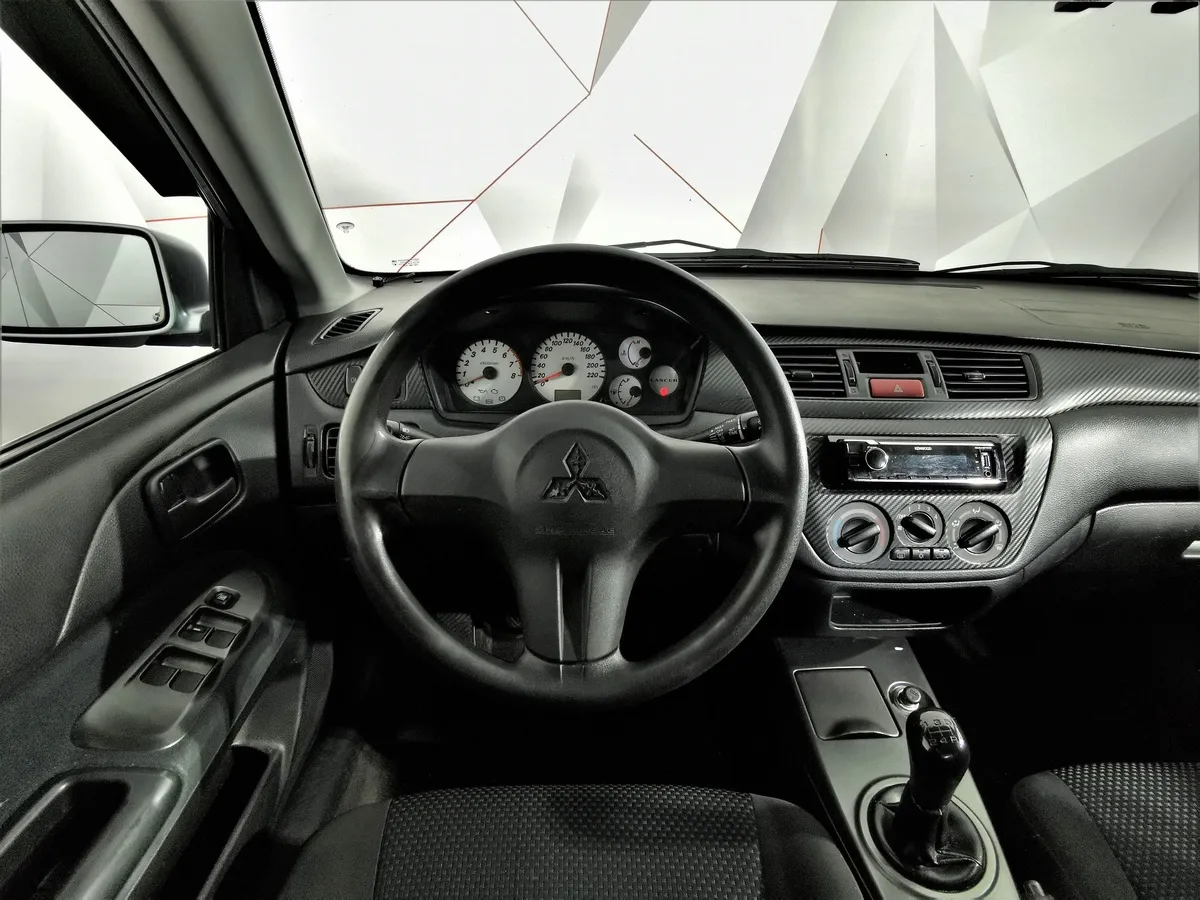 Mitsubishi Lancer 1.6 MT (98 л.с.) Серый в АВИЛОН. Слайд №19
